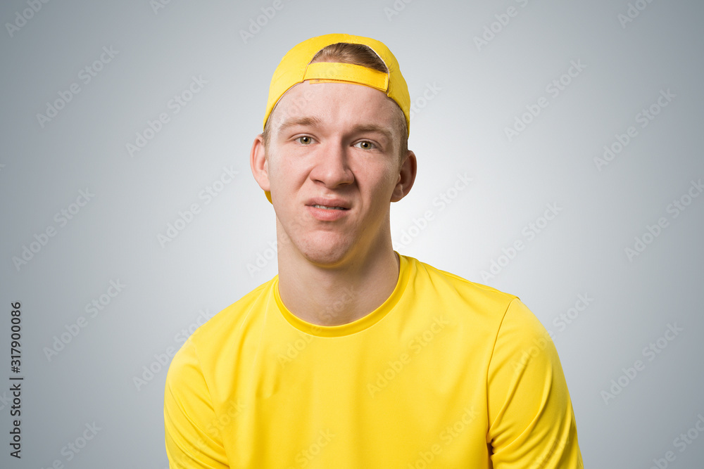 Unhappy young guy looking at camera