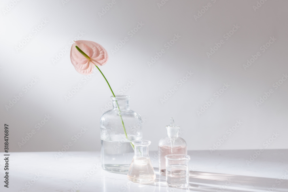 Beautiful composition with perfume samples and flowers on table