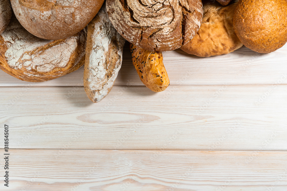 Different types of bread on a wooden background