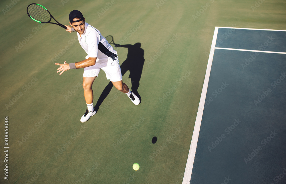 Tennis player hitting a forehand from baseline.