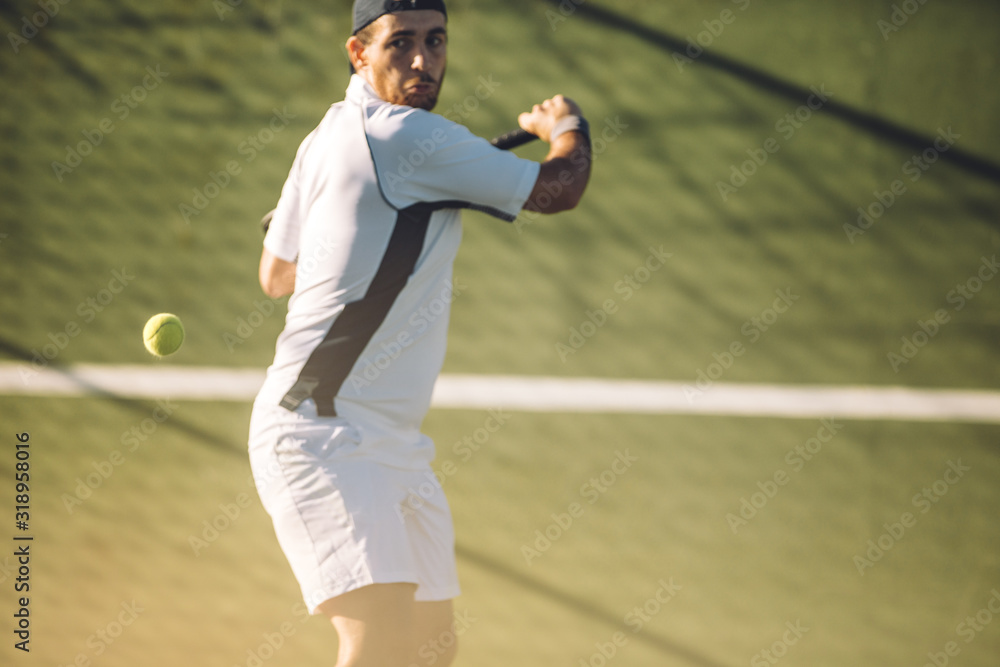 Tennis player hitting a powerful backhand