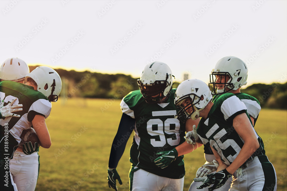 American football team celebrating together after a win