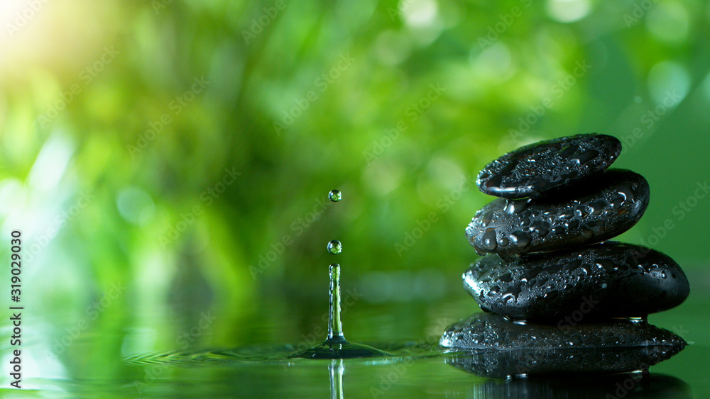 Dripping drops of water with black lava stones