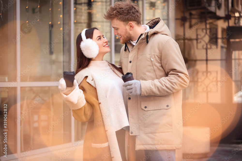 Happy young couple walking outdoors on winter day