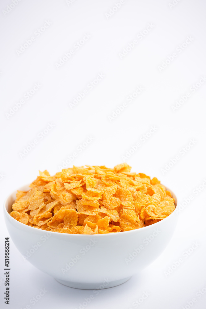 Natural corn flake breakfast cereal in cups and milk is a healthy breakfast that is good for your bo