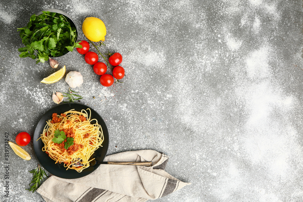 Plate with tasty pasta bolognese on grey background