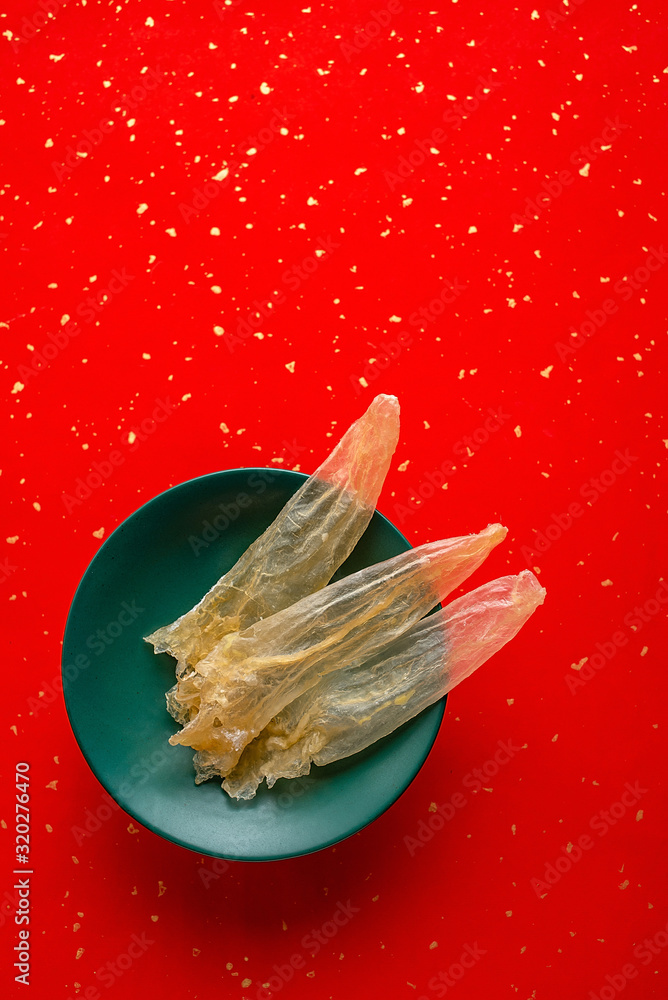 A plate of golden yellow mucilan caramel on a red background