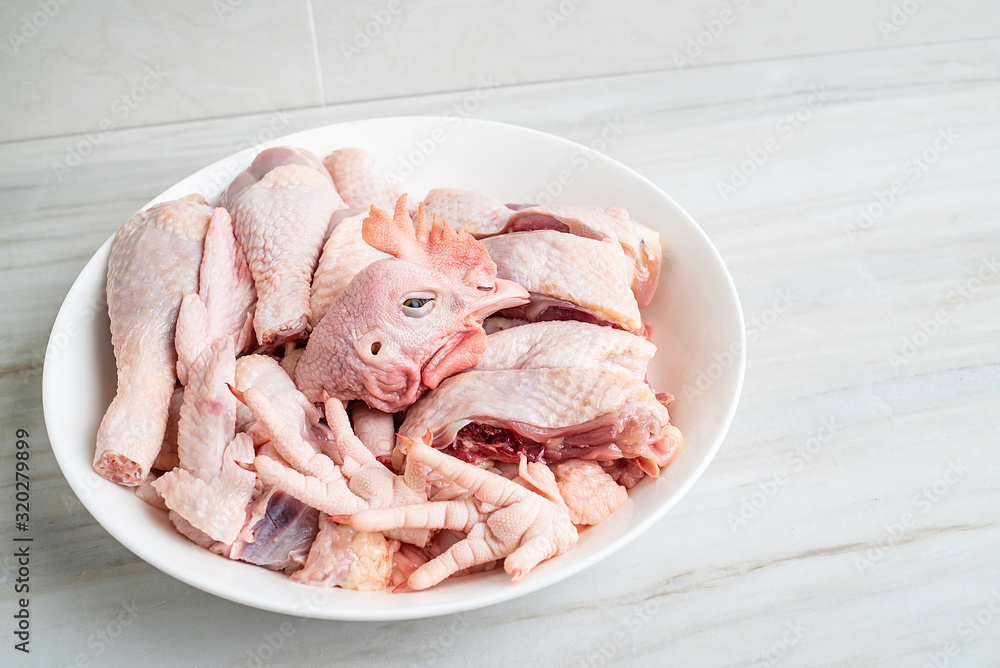 A dish of diced chicken on a kitchen tile countertop