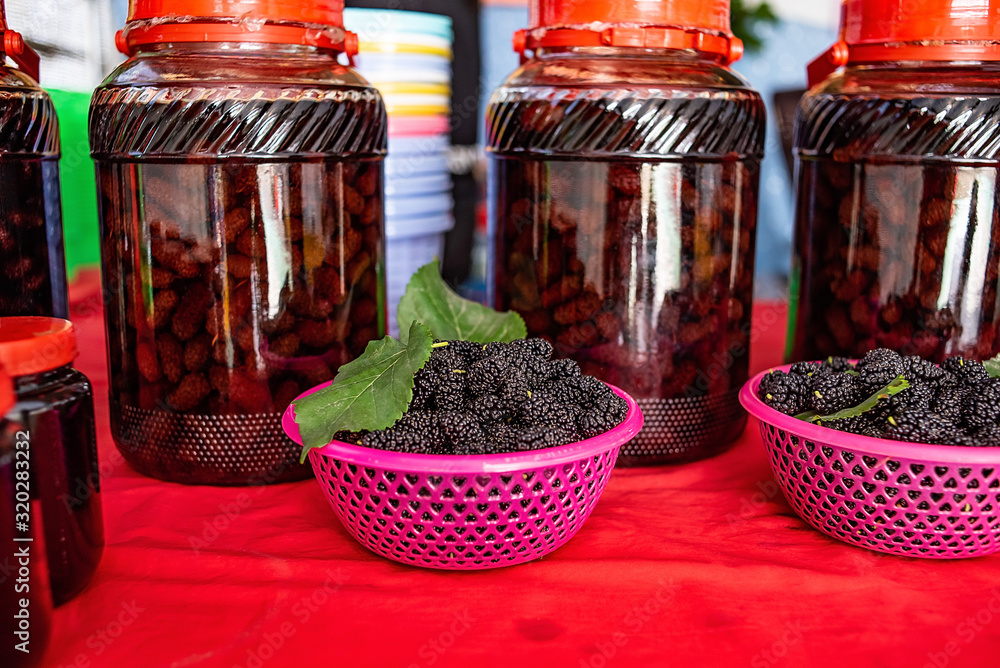 Freshly picked mulberry and mulberry wine