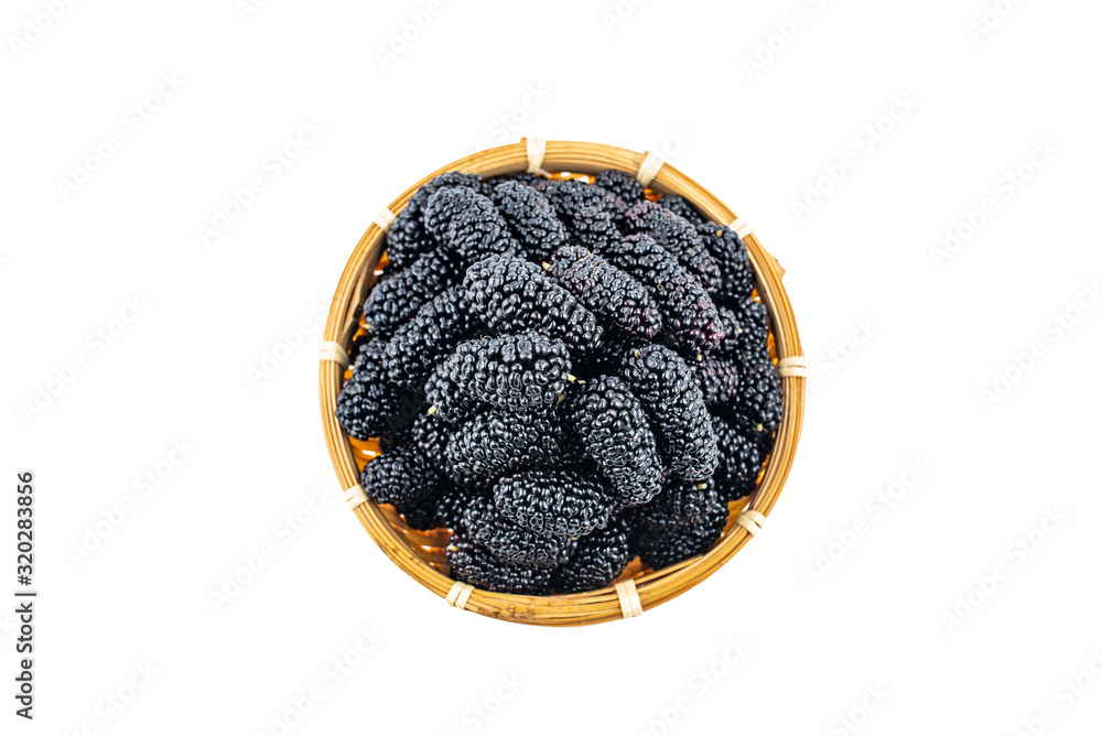 A bamboo dish filled with fresh black mulberries on a white background