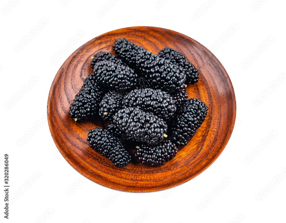 Fresh black mulberry on a saucer on white background