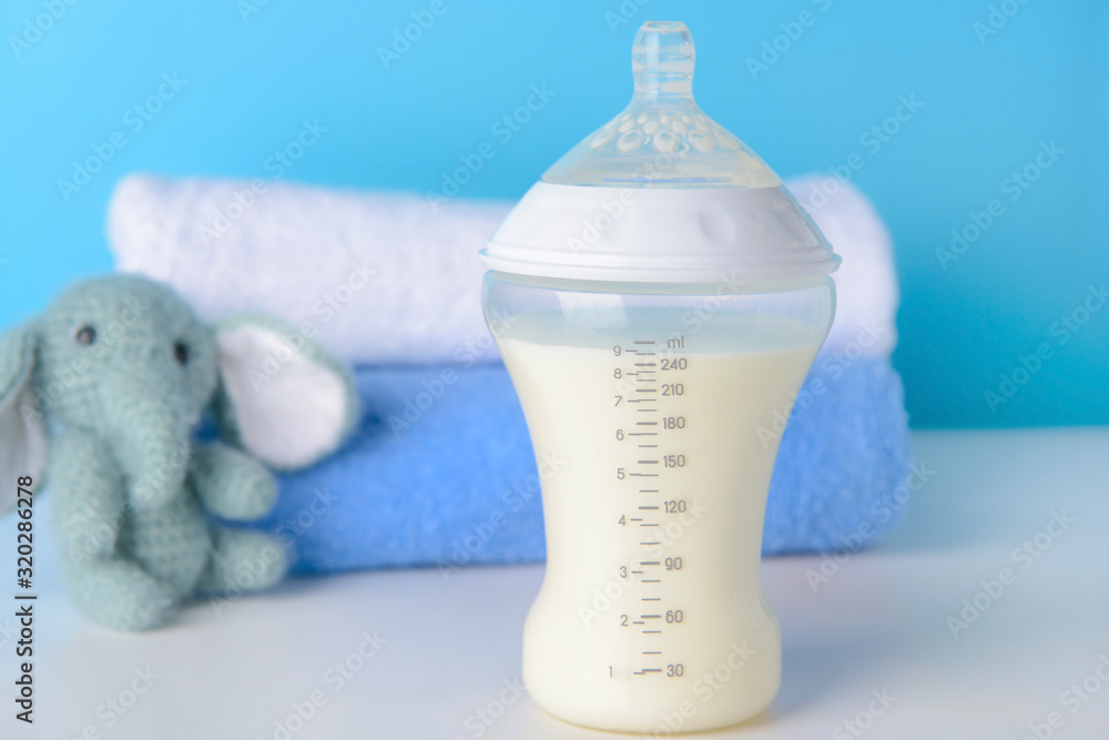 Bottle of milk for baby on table