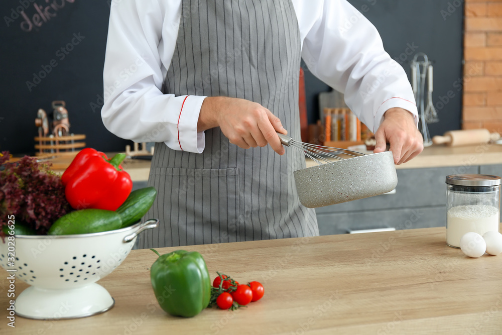 Male chef cooking in kitchen