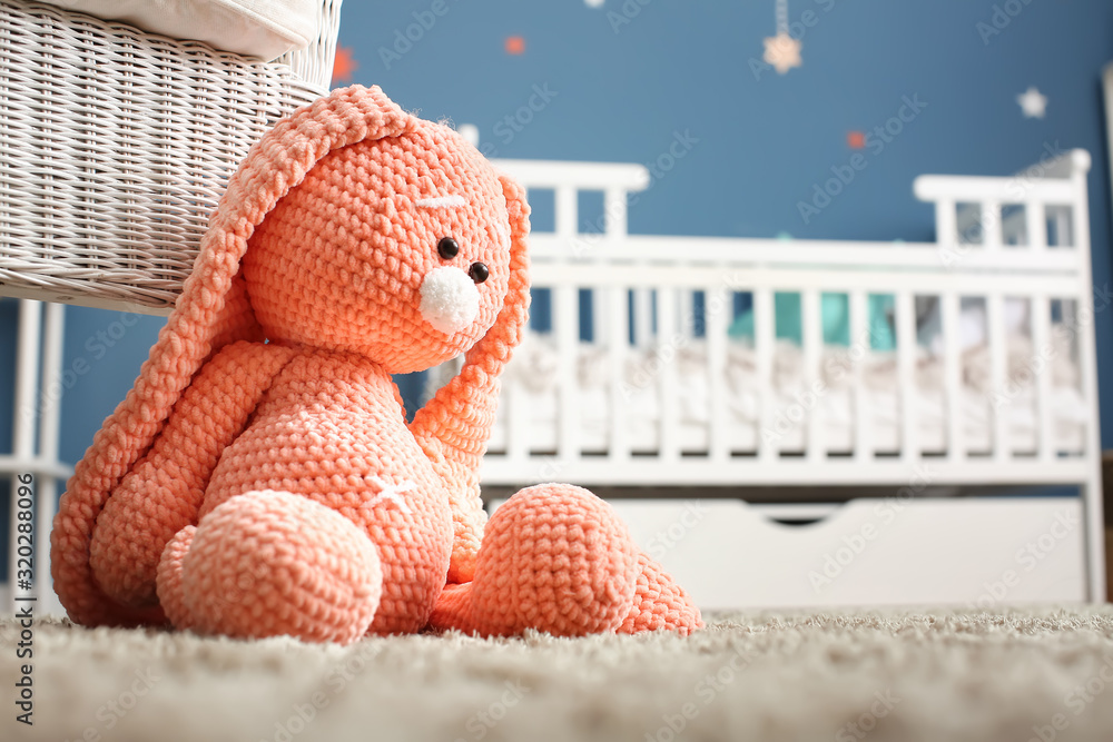 Cute baby toy on floor in room