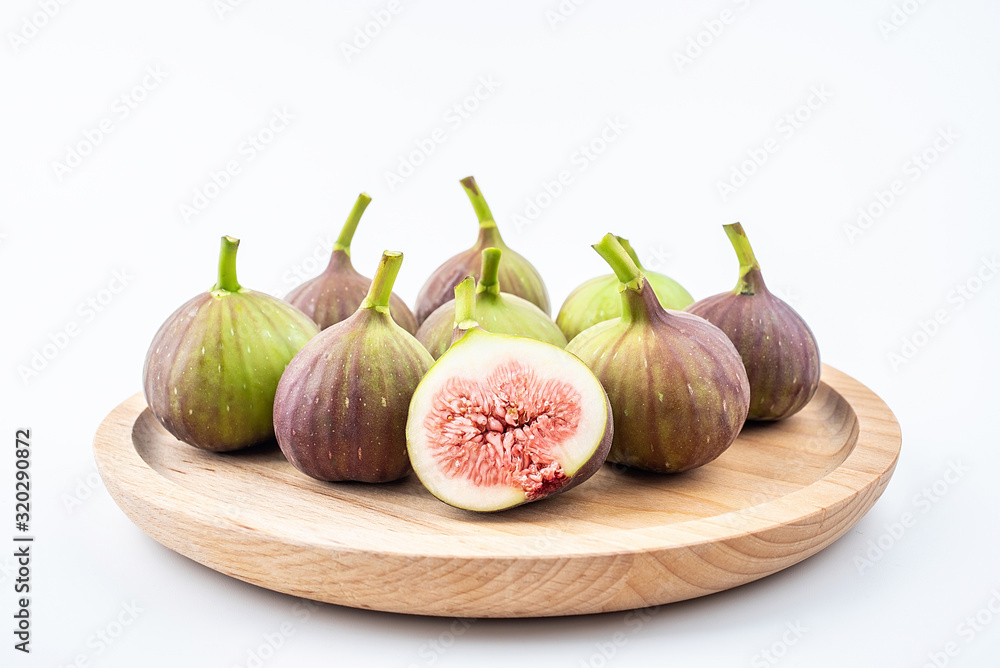 Fresh fruit figs on a saucer on white background