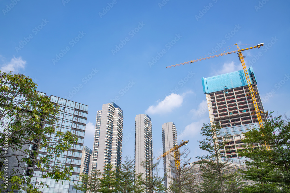 Upside-down shot of city construction site cranes and real estate