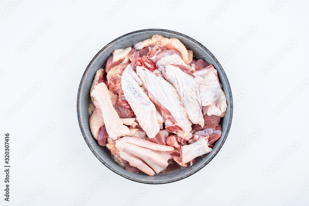 Freshly chopped duck meat on a saucer on white background