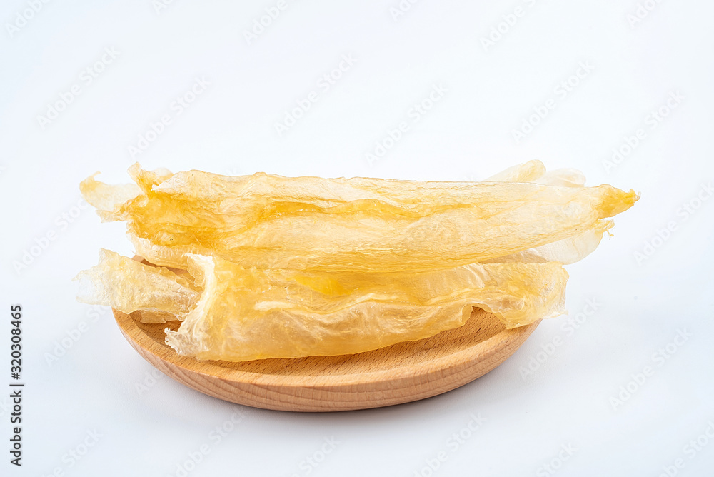 Tonic Food Maw Catfish Gum on a saucer on white background