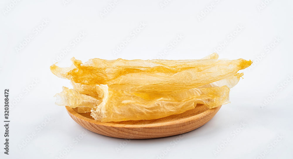 Tonic Food Maw Catfish Gum on a saucer on white background