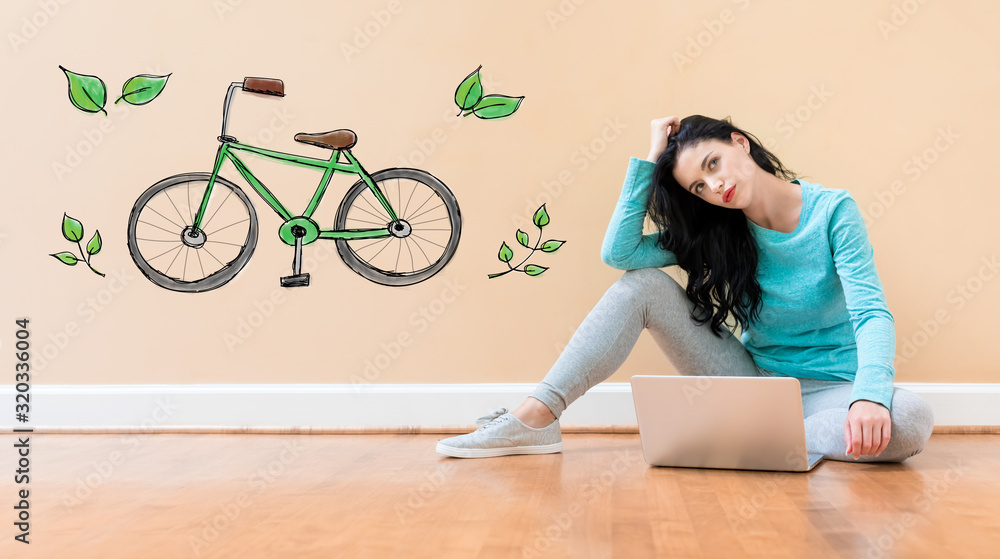 Eco bicycle with young woman using a laptop computer