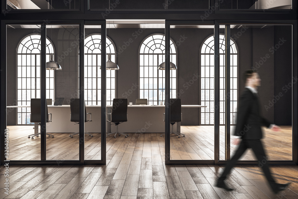 Businessman walking in conference room in loft interior