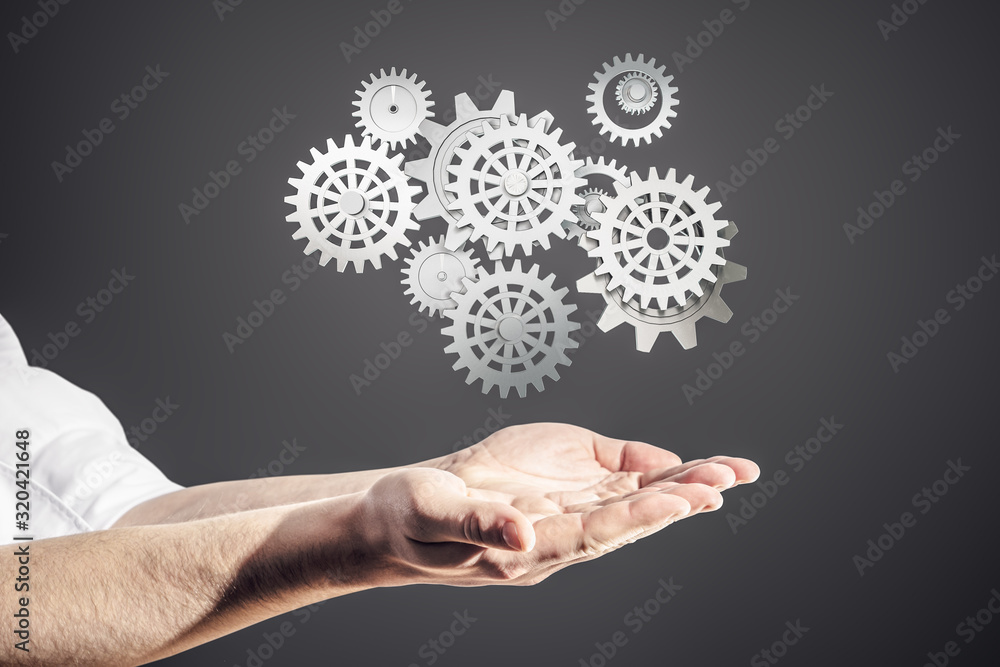 Hands businessman holding cogs and gears system