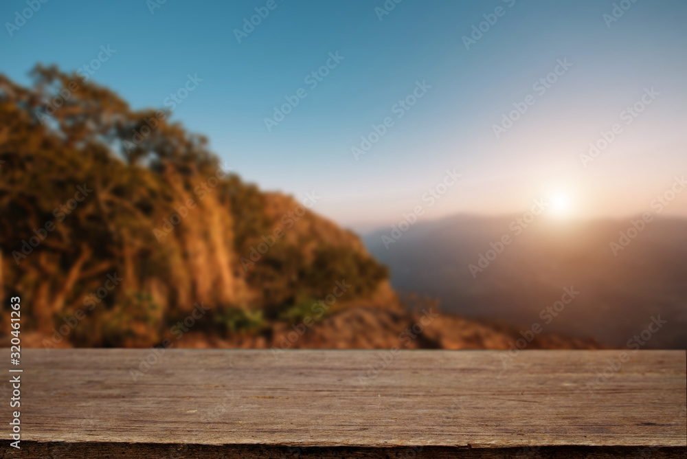 Wood table top in front of of trees in the forest. blur background image, for product display montag