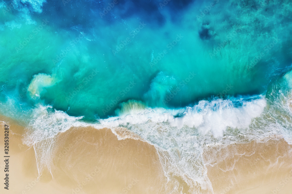 Waves and beach. Coast as a background from top view. Turquoise water background from air. Nusa Peni