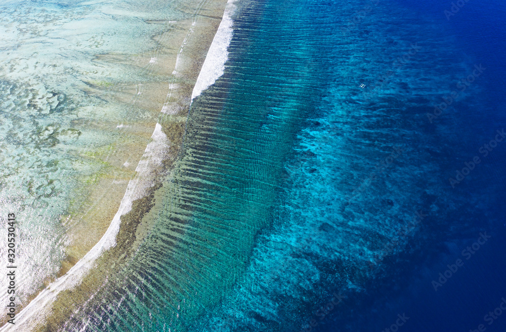 View on the coral reef. Azure water background from top view. Summer seascape from air. Travel - ima