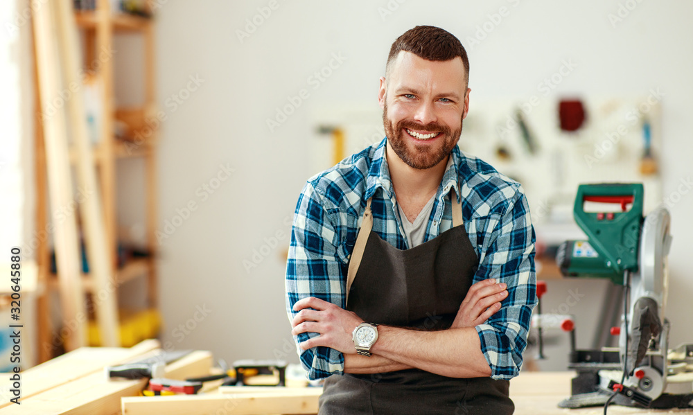 young male carpenter working in  workshop.