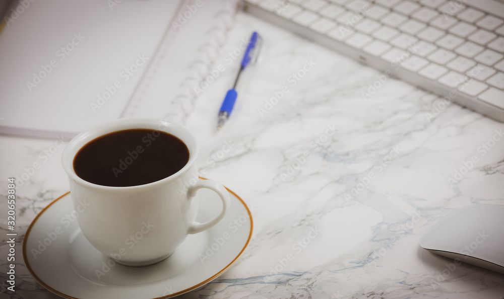 Black coffee on the desk with a computer, mouse Keyboard, book note, and pen Concept of working at h