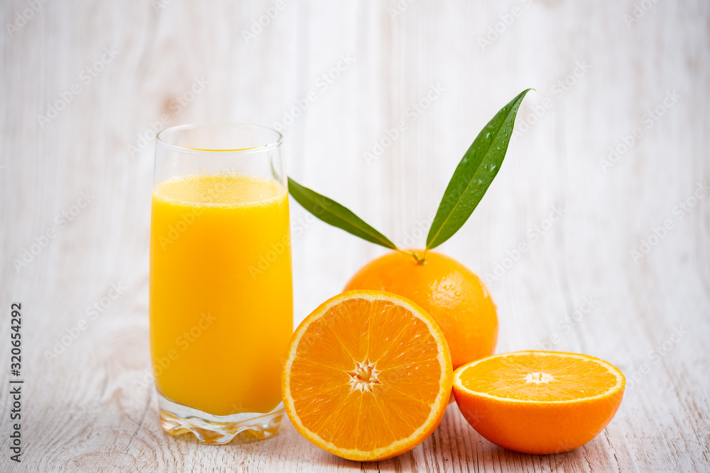 Natural fresh fruit oranges in a wooden background backdrop, half cut oranges, orange juice, vitamin