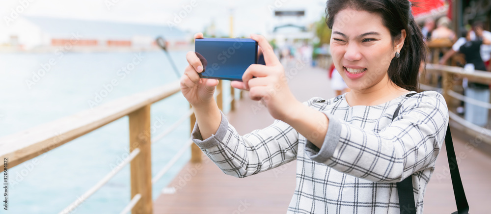 closeup asian woman hand smartphone selfie traveller with background of house architecture,asian pho