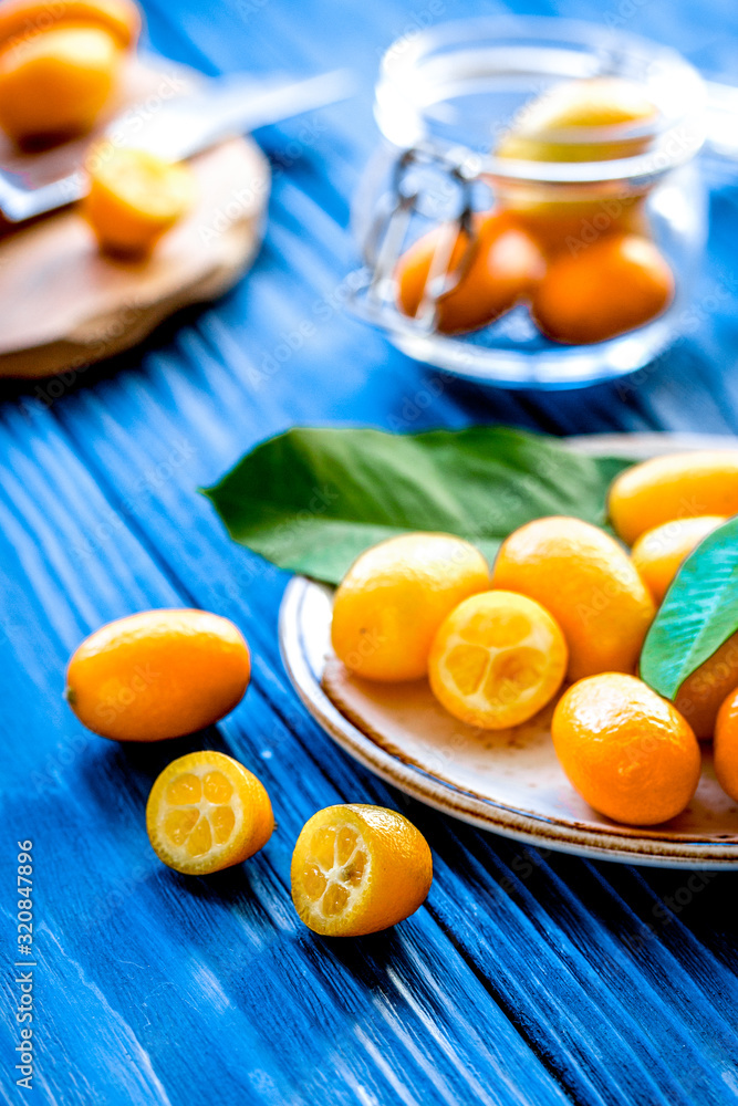 kumquat on plate at wooden table