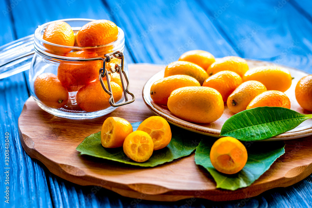 kumquat on plate at wooden table