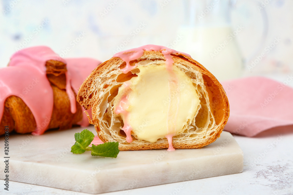 Board with tasty sweet croissants on white background, closeup