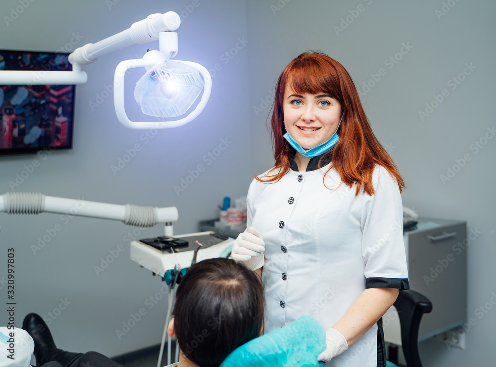 At the dentist. Female dentist in action