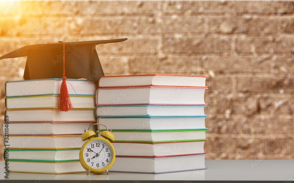 Graduation hat and stack of books