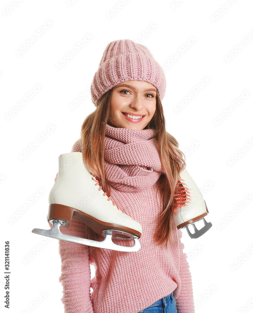 Beautiful young woman with ice skates on white background