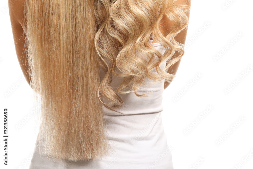 Beautiful young woman with curly and straight hair on white background