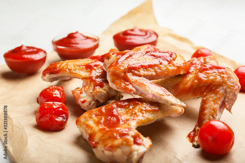 Cooked chicken wings with tomato sauce on table