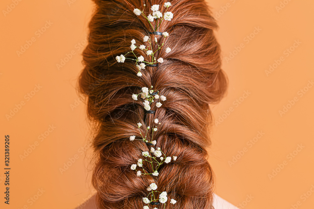 Young woman with beautiful hairdo on color background