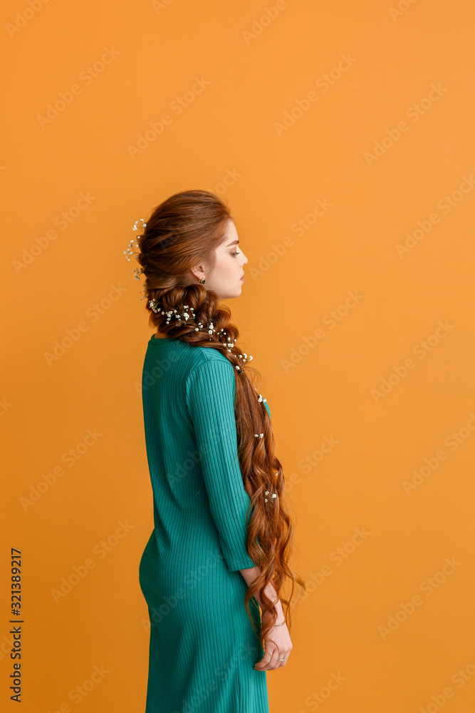 Young woman with beautiful hairdo on color background