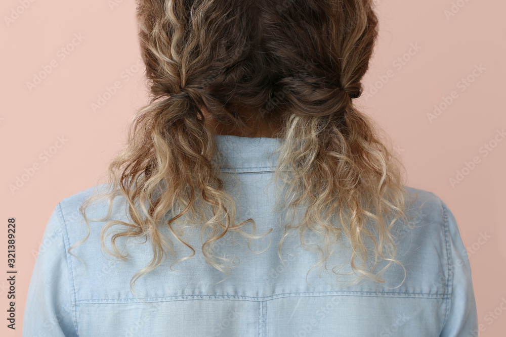 Young woman with beautiful hairdo on color background