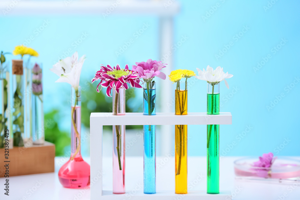 Test tubes with flowers on table in laboratory