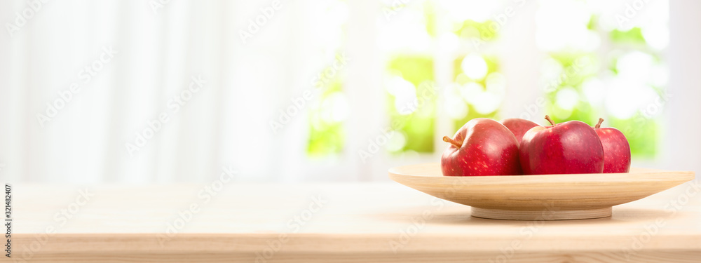 Fresh Ripe red apples in bowl on wooden table