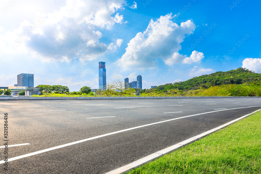 Empty asphalt road and Shenzhen city architectural scenery,China.