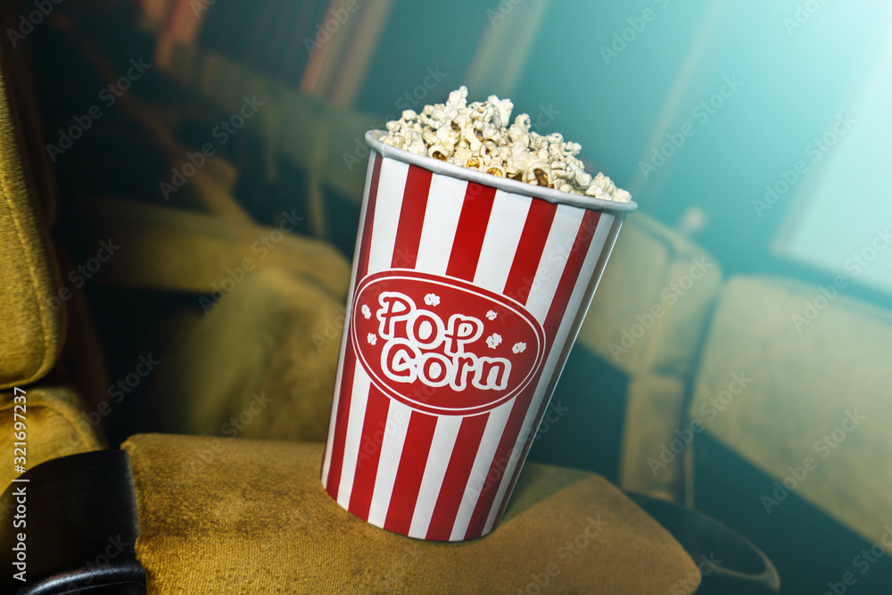 A row of yellow seat with popcorn on chair in the movie theater