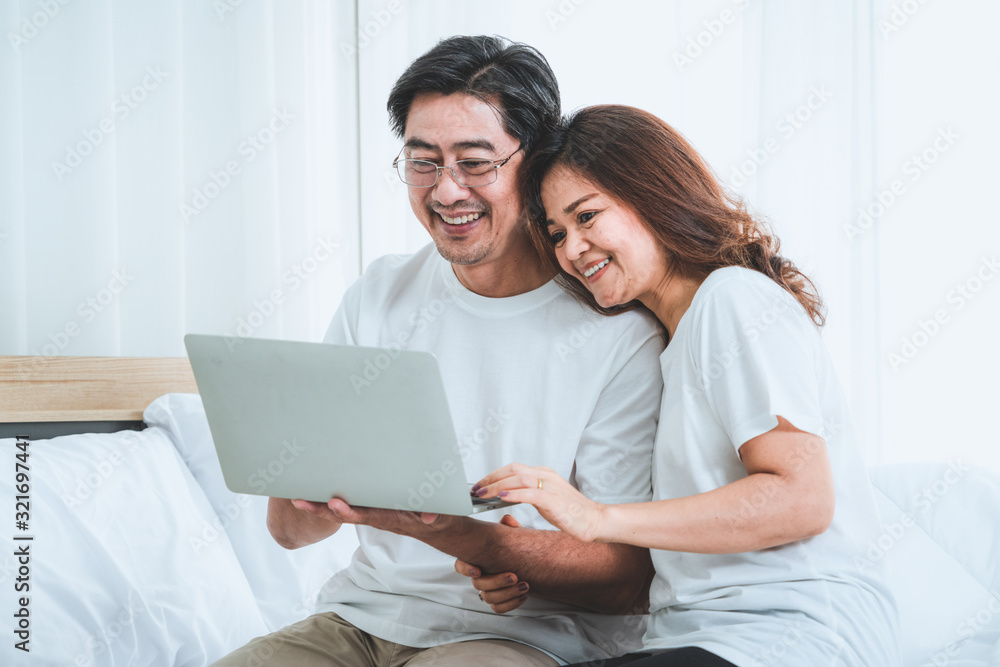 Happy Asian senior couple having good time at home. Old people retirement and healthy citizens elder