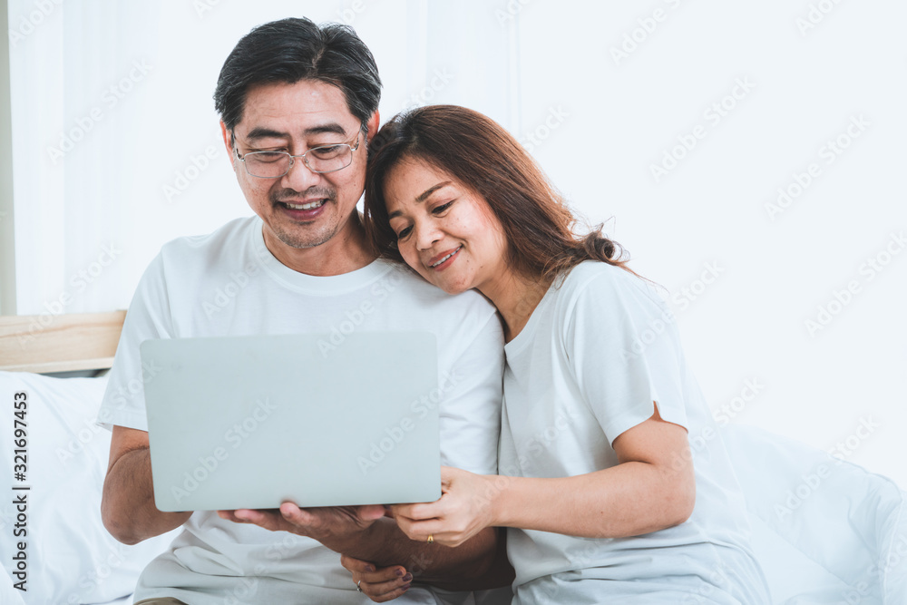 Happy Asian senior couple having good time at home. Old people retirement and healthy citizens elder